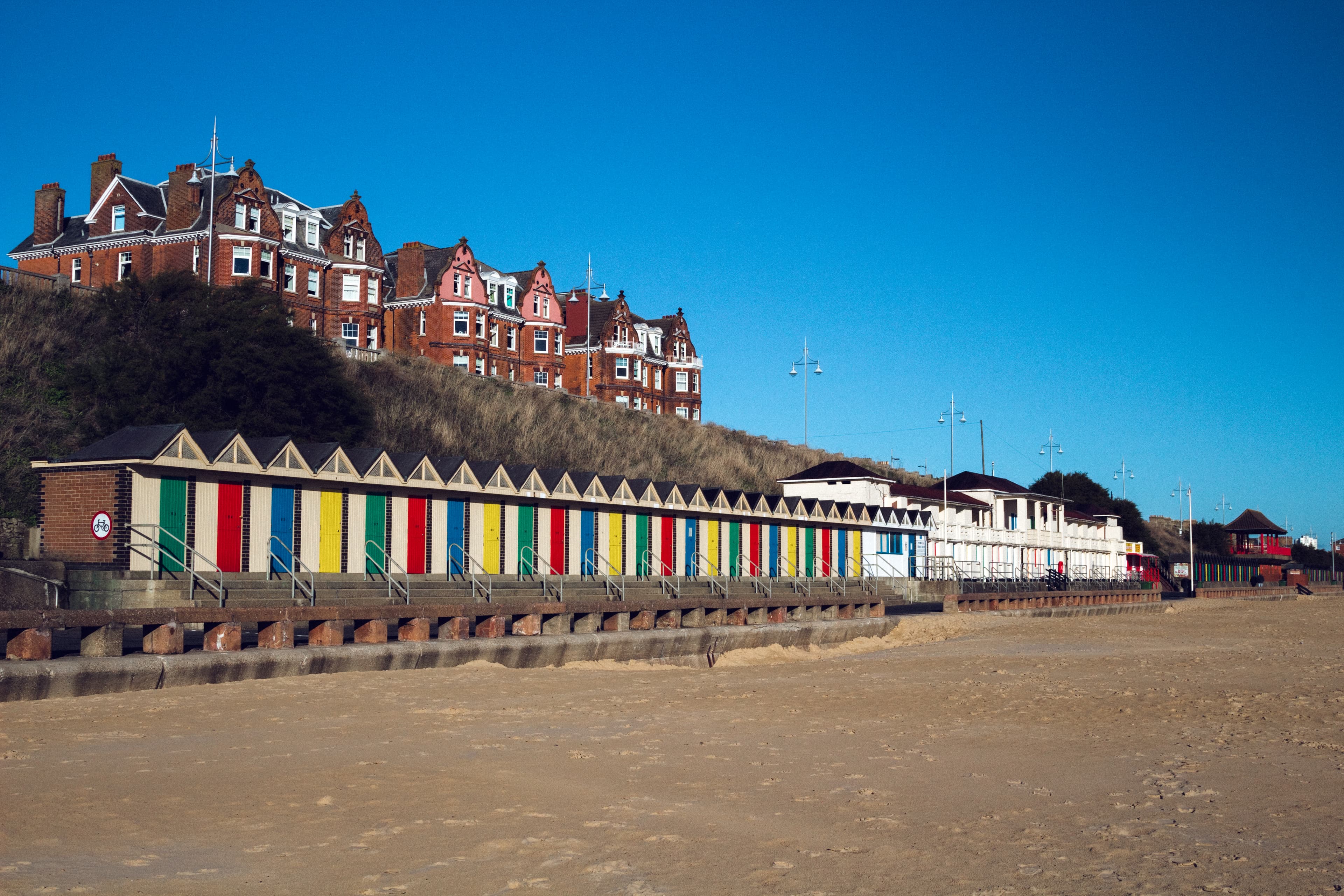 Colourful beach huts line the seafront at Lowestoft, adding charm to this classic English coastal destination known for its sandy beaches and scenic promenade.