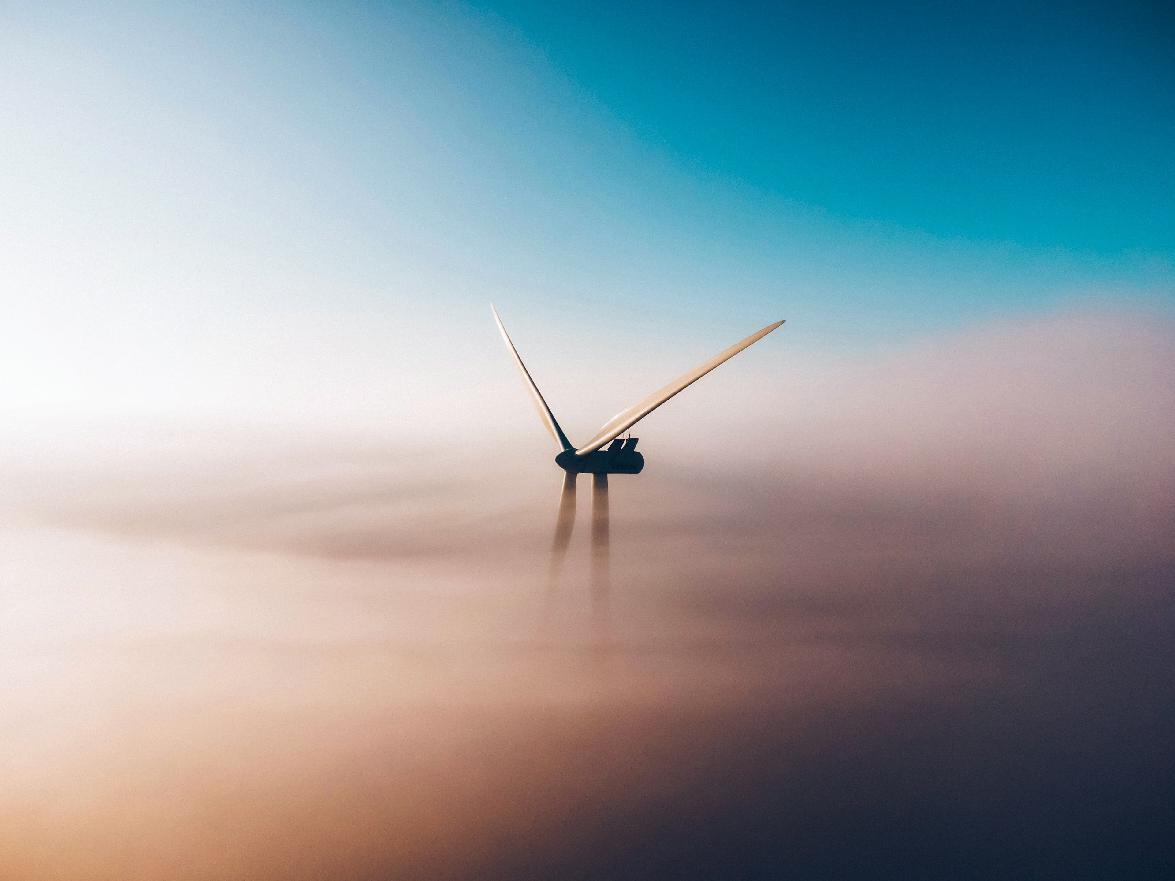 Wind Turbine through the clouds blue skies